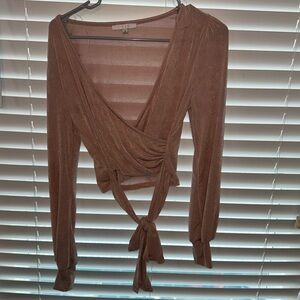 Beige stretch material Iris long sleeve top that ties around the waist